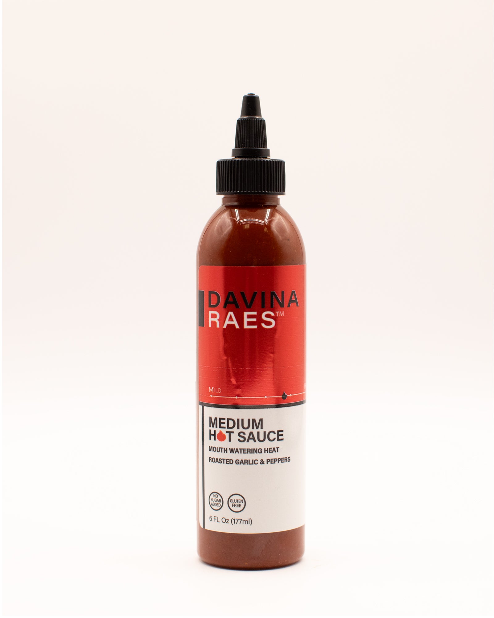 Bottle of Davina Raes medium hot sauce on a white background
